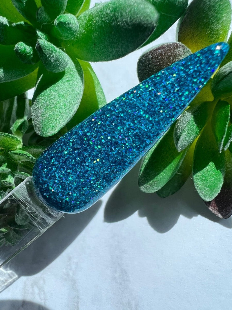 Photo shows swatch of Dipnotic Nails Aloha Blue Holographic Nail Dip Powder The Hello Holo Collection