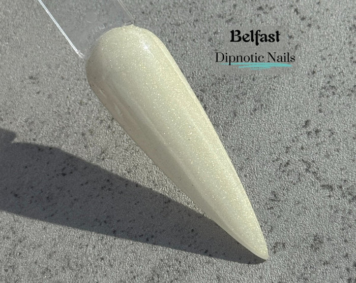 Photo shows swatch of Dipnotic Nails Belfast Pale Gold Nail Dip Powder The Emerald Isle Collection Pt. 2