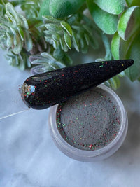 Photo shows swatch of Dipnotic Nails Black Tie Christmas Black Red and Green Christmas Nail Dip Powder