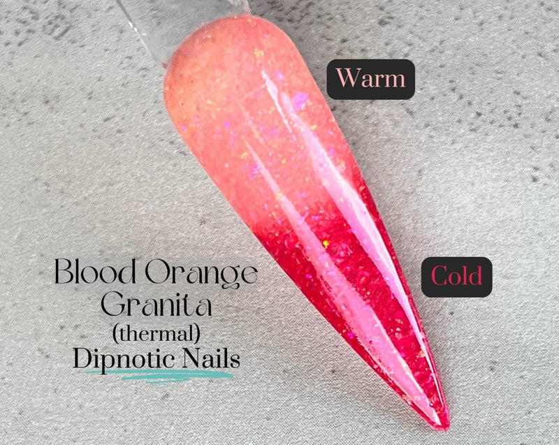 Photo shows swatch of Dipnotic Nails Blood Orange Granita Coral Thermal Nail Dip Powder The Citrus Sunrise Collection