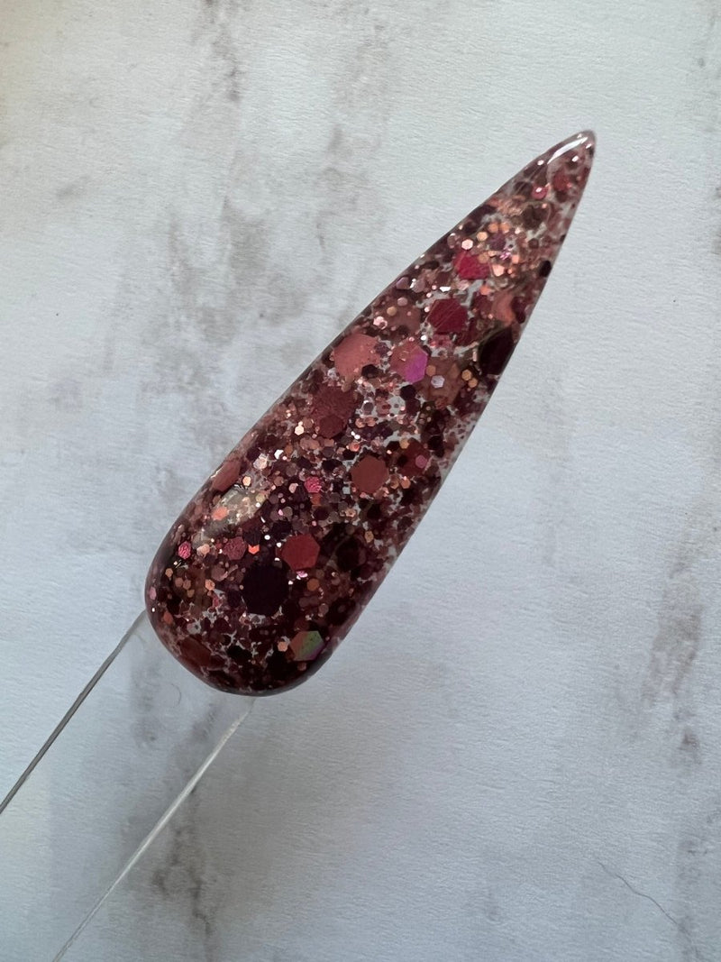 Photo shows swatch of Dipnotic Nails Burgundy Rose Gold Holographic Nail Dip Powder