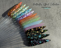 Photo shows swatch of Dipnotic Nails Butterfly Effect Black, Green, and Blue Foil Nail Dip Powder The Butterfly Effect Collection