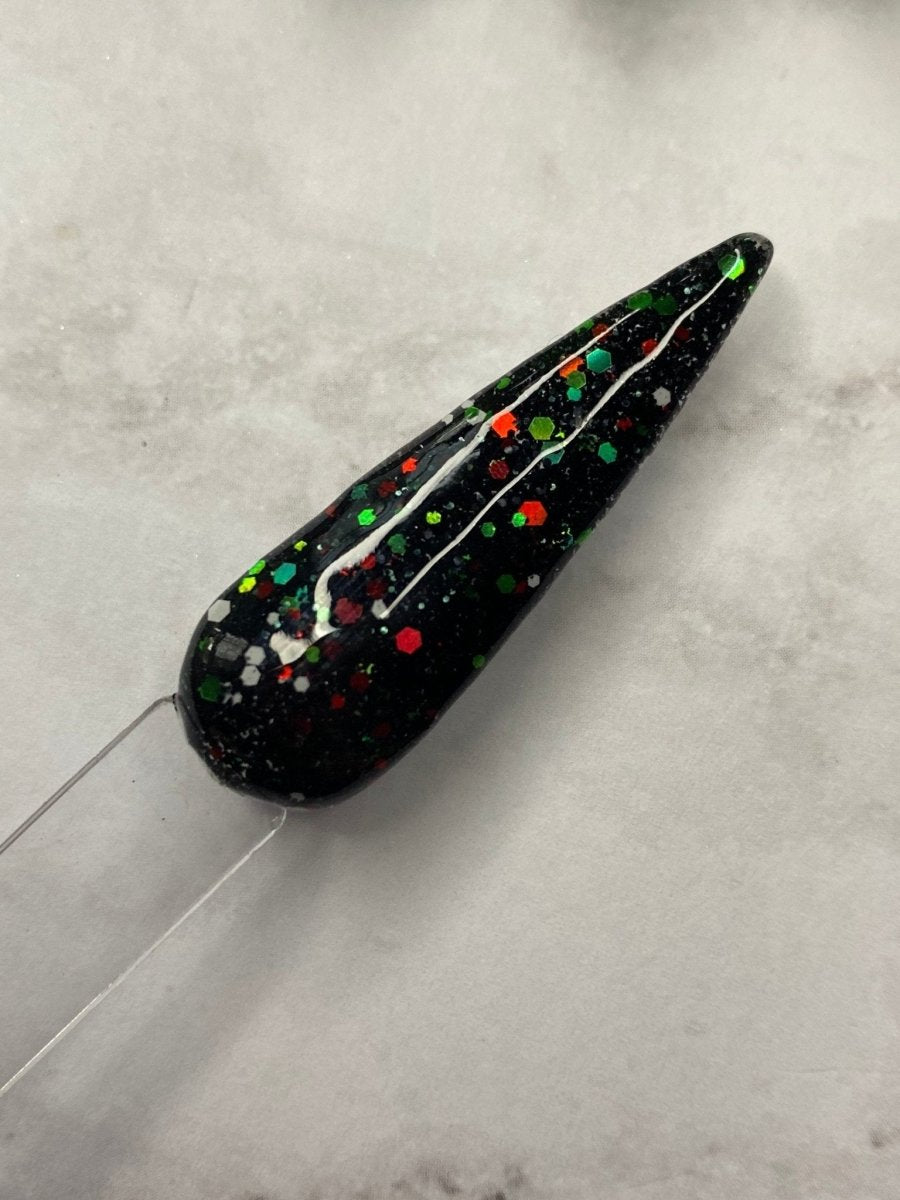 Photo shows swatch of Dipnotic Nails Christmas Coal Black Red and Green Christmas Nail Dip Powder