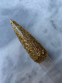 Photo shows swatch of Dipnotic Nails Christmas Eve Gold Red and Green Christmas Nail Dip Powder