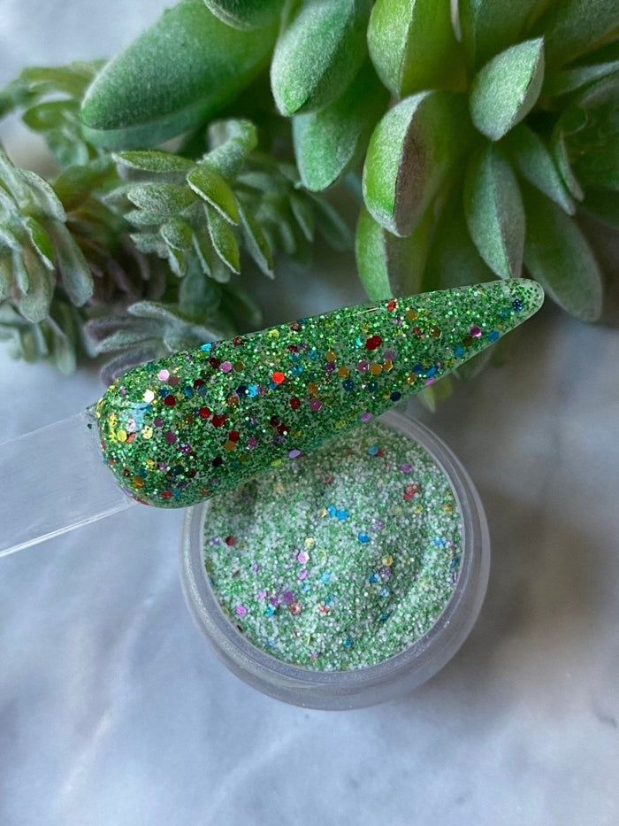 Photo shows swatch of Dipnotic Nails Christmas Tree Green Christmas Nail Dip Powder