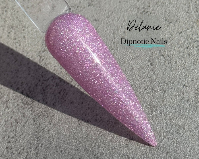 Photo shows swatch of Dipnotic Nails Delanie Purple Chameleon Nail Dip Powder The Butterfly Effect Collection