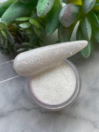 Photo shows swatch of Dipnotic Nails Diamond Dust April Birthstone White Glitter Nail Dip Powder