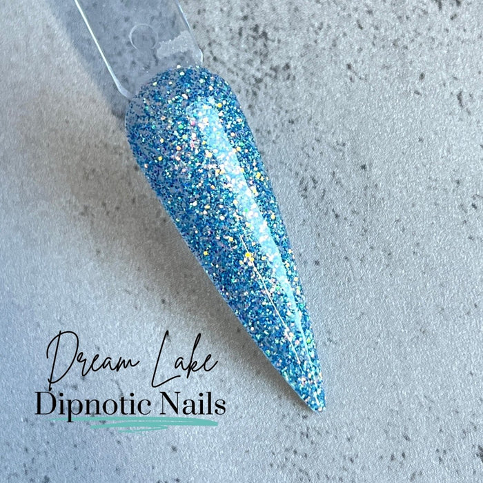 Photo shows swatch of Dipnotic Nails Dream Lake Iridescent Blue Dip Powder The Colorado Winter Collection