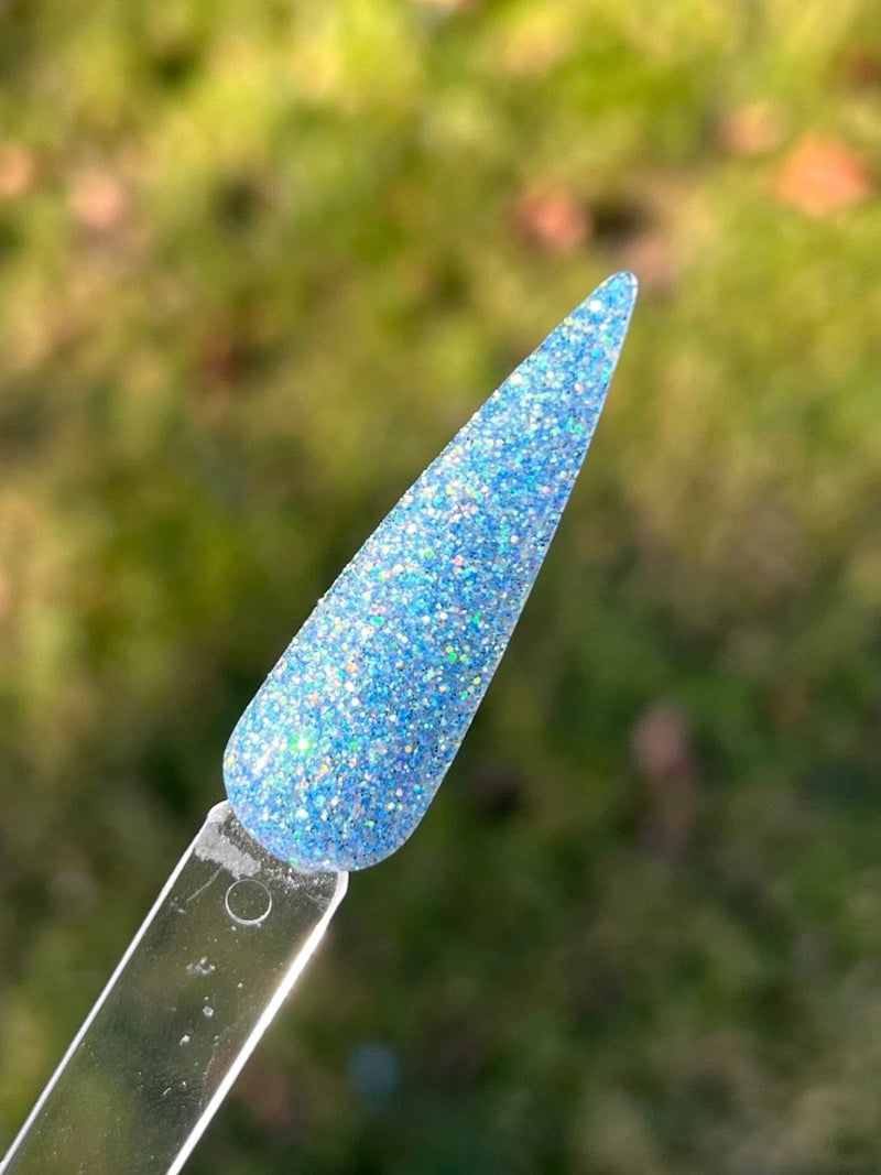 Photo shows swatch of Dipnotic Nails Dream Lake Iridescent Blue Dip Powder The Colorado Winter Collection