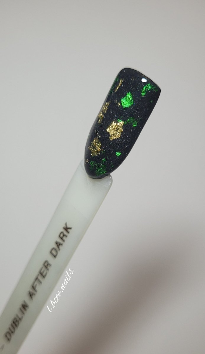 Photo shows swatch of Dipnotic Nails Dublin After Dark Black, Green, and Gold Foil Nail Dip Powder The Dublin After Dark Collection
