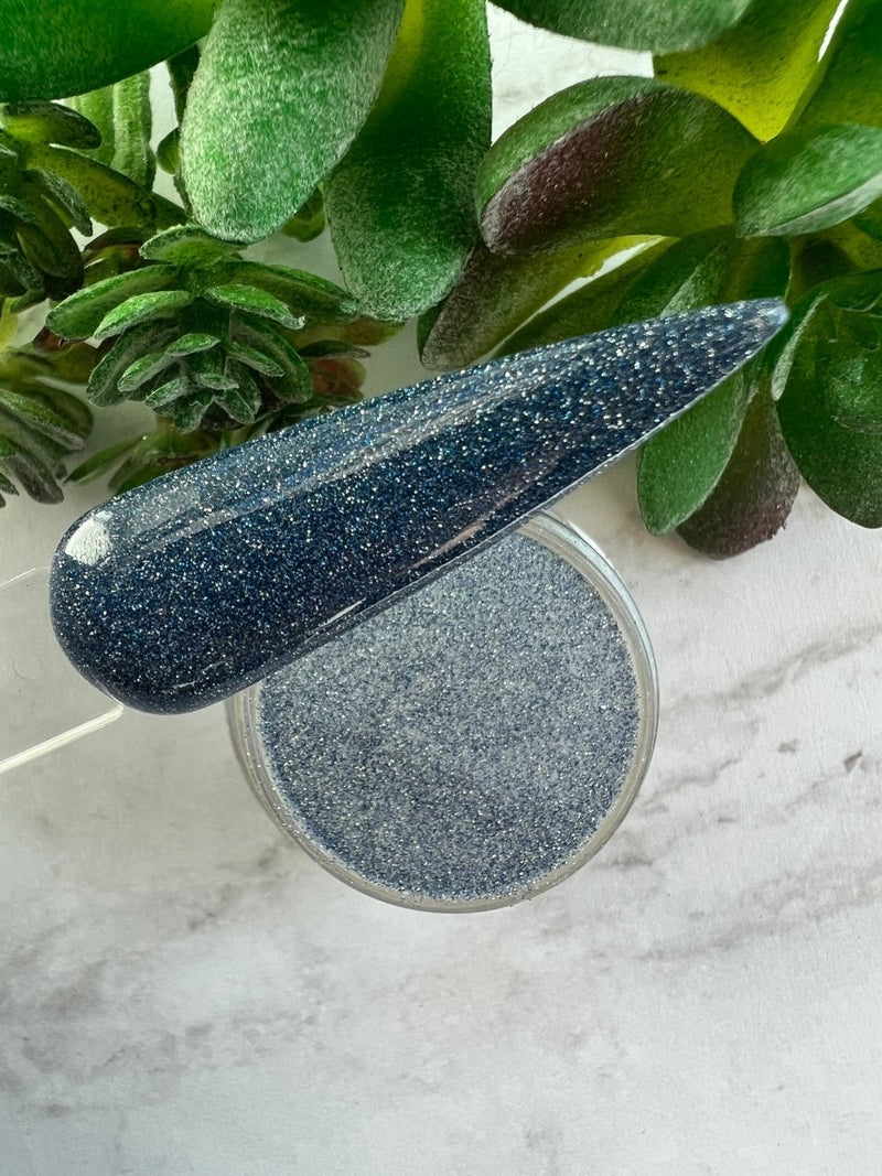 Photo shows swatch of Dipnotic Nails Echo Dark Blue Reflective Glitter Nail Dip Powder