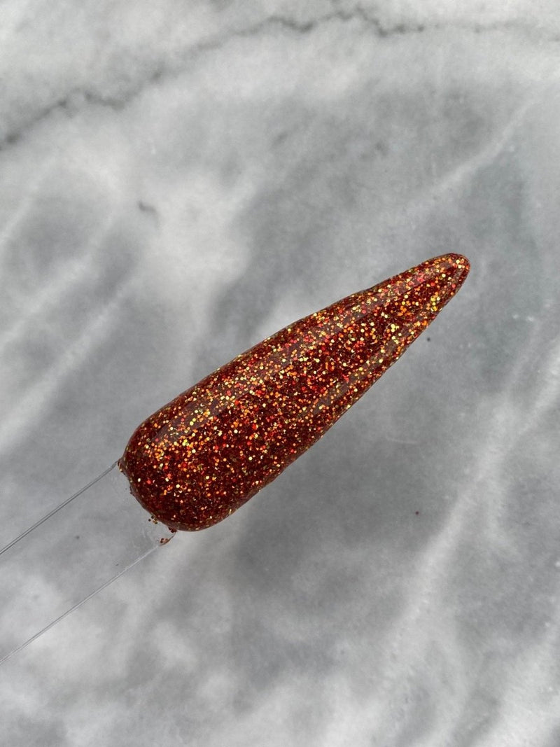 Photo shows swatch of Dipnotic Nails Falling Leaves 2 Golden Orange Nail Dip Powder