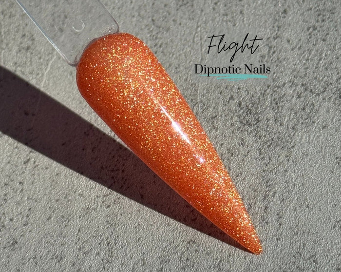 Photo shows swatch of Dipnotic Nails Flight Orange Nail Dip Powder The Butterfly Effect Collection