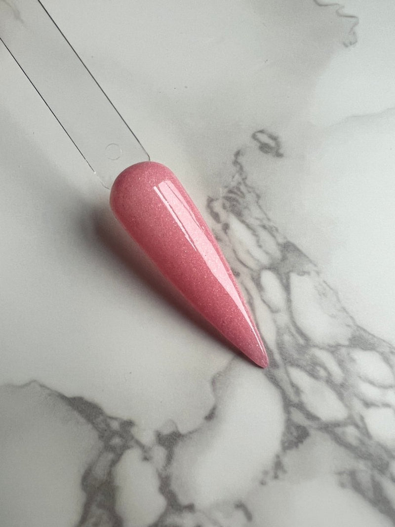 Photo shows swatch of Dipnotic Nails Flirty Bubble Gum Pink Dip Powder The Love Struck Collection