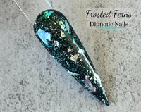 Photo shows swatch of Dipnotic Nails Frosted Ferns Dark Green and Silver Nail Dip Powder The Solstice Soiree Collection