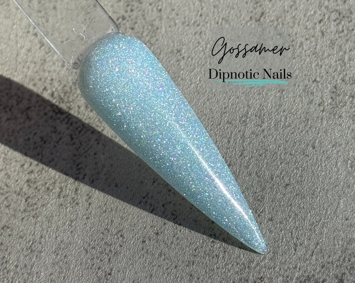 Photo shows swatch of Dipnotic Nails Gossamer Blue Chameleon Nail Dip Powder The Butterfly Effect Collection