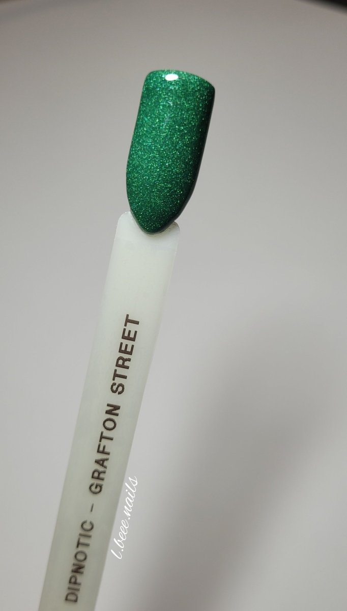 Photo shows swatch of Dipnotic Nails Grafton Street Green Nail Dip Powder The Dublin After Dark Collection