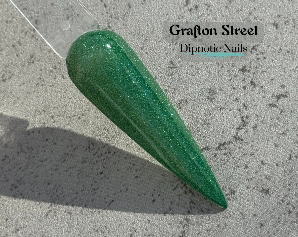 Photo shows swatch of Dipnotic Nails Grafton Street Green Nail Dip Powder The Dublin After Dark Collection