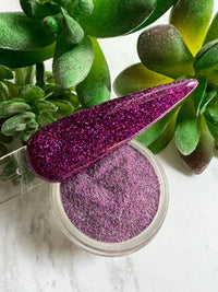 Photo shows swatch of Dipnotic Nails Guten Tag Purple Holographic Nail Dip Powder The Hello Holo Collection