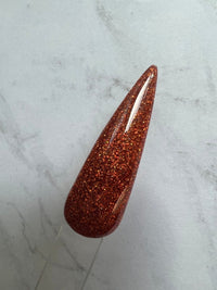 Photo shows swatch of Dipnotic Nails Hola Orange Holographic Nail Dip Powder The Hello Holo Collection