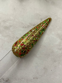 Photo shows swatch of Dipnotic Nails Holiday Cheer Gold Red and Green Christmas Nail Dip Powder