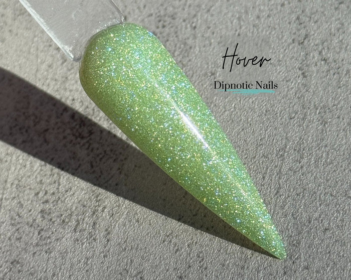 Photo shows swatch of Dipnotic Nails Hover Green Chameleon Nail Dip Powder The Butterfly Effect Collection