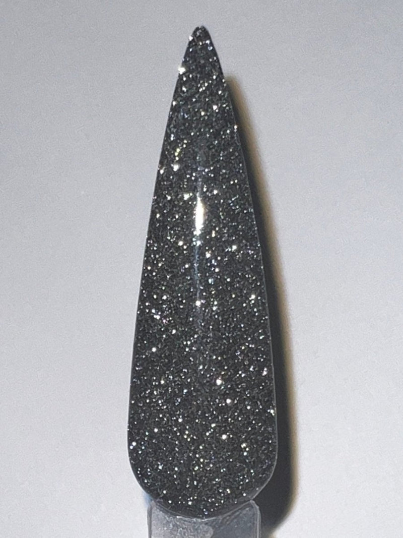 Photo shows swatch of Dipnotic Nails Impression Black Reflective Glitter Nail Dip Powder