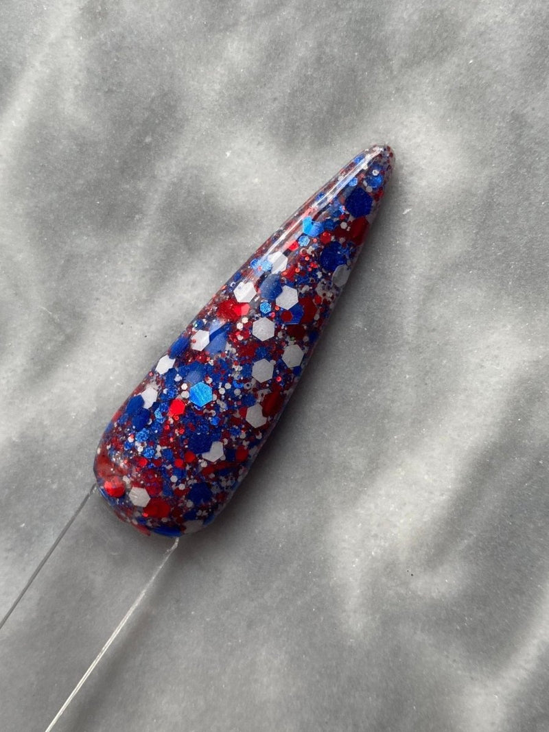 Photo shows swatch of Dipnotic Nails Independence Day Red White and Blue Patriotic Nail Dip Powder