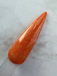 Photo shows swatch of Dipnotic Nails Leo Orange Nail Dip Powder Stardust Collection