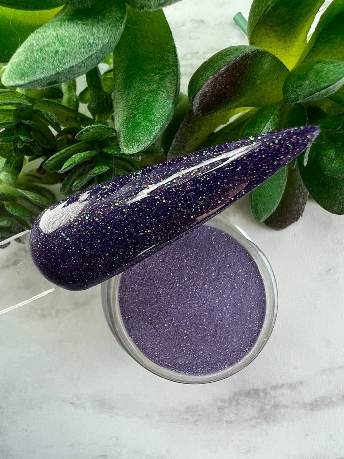 Photo shows swatch of Dipnotic Nails Libra Purple Nail Dip Powder Stardust Collection