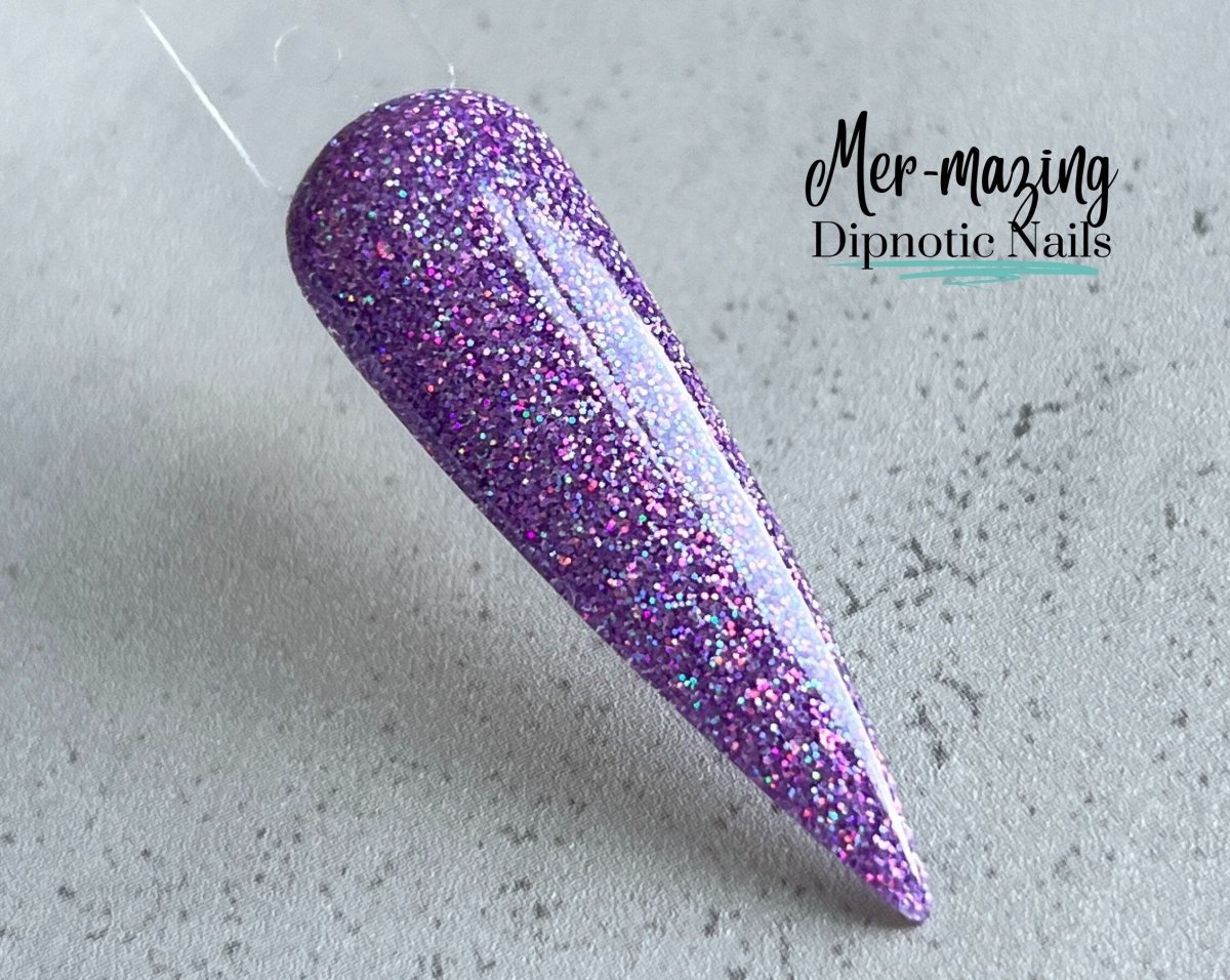 Photo shows swatch of Dipnotic Nails Mer-mazing Purple Holographic Nail Dip Powder The Mermaid Magic Collection