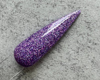Photo shows swatch of Dipnotic Nails Mer-mazing Purple Holographic Nail Dip Powder The Mermaid Magic Collection