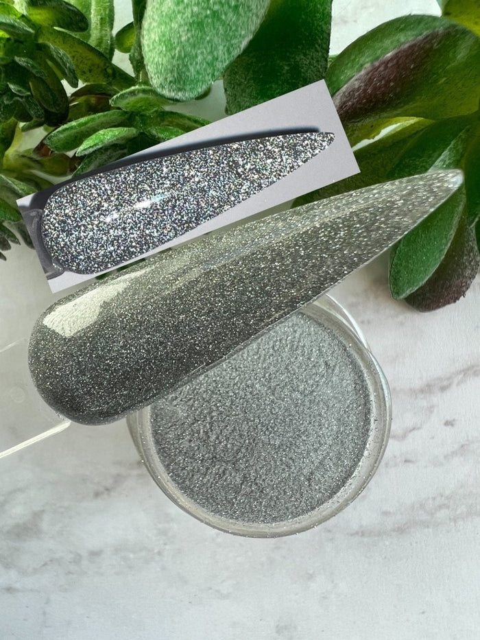 Photo shows swatch of Dipnotic Nails Mirror Silver Reflective Glitter Nail Dip Powder
