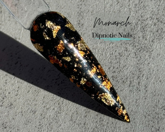 Photo shows swatch of Dipnotic Nails Monarch Black, Gold, and Orange Foil Nail Dip Powder The Butterfly Effect Collection