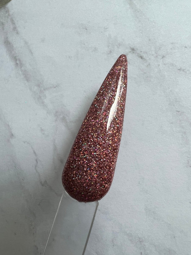 Photo shows swatch of Dipnotic Nails Namaste Rose Gold Holographic Nail Dip Powder The Hello Holo Collection