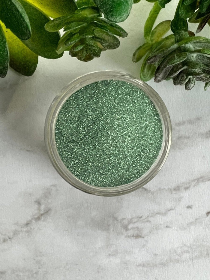 Photo shows swatch of Dipnotic Nails Nessie Green Nail Dip Powder