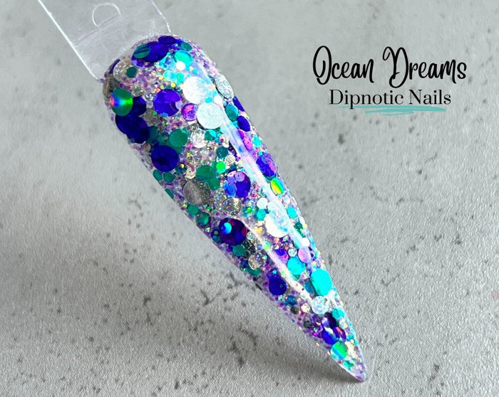 Photo shows swatch of Dipnotic Nails Ocean Dreams Teal Purple and Silver Iridescent Nail Dip Powder The Mermaid Magic Collection