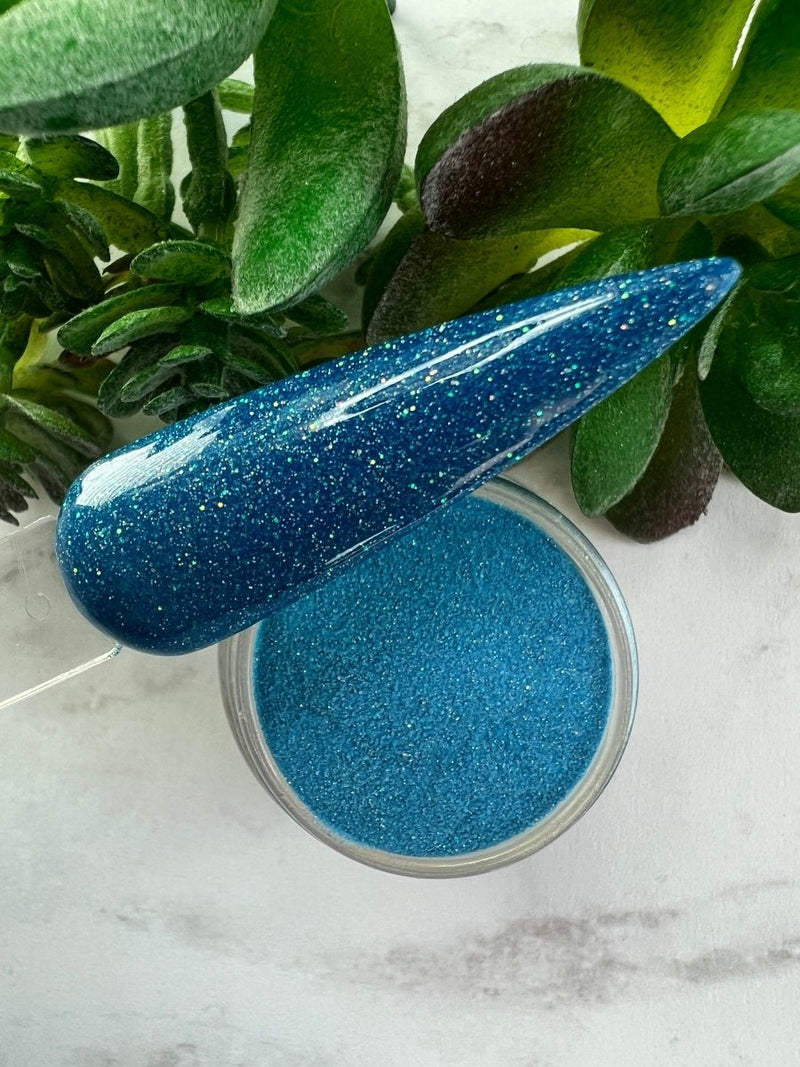 Photo shows swatch of Dipnotic Nails Pisces Blue Nail Dip Powder Stardust Collection