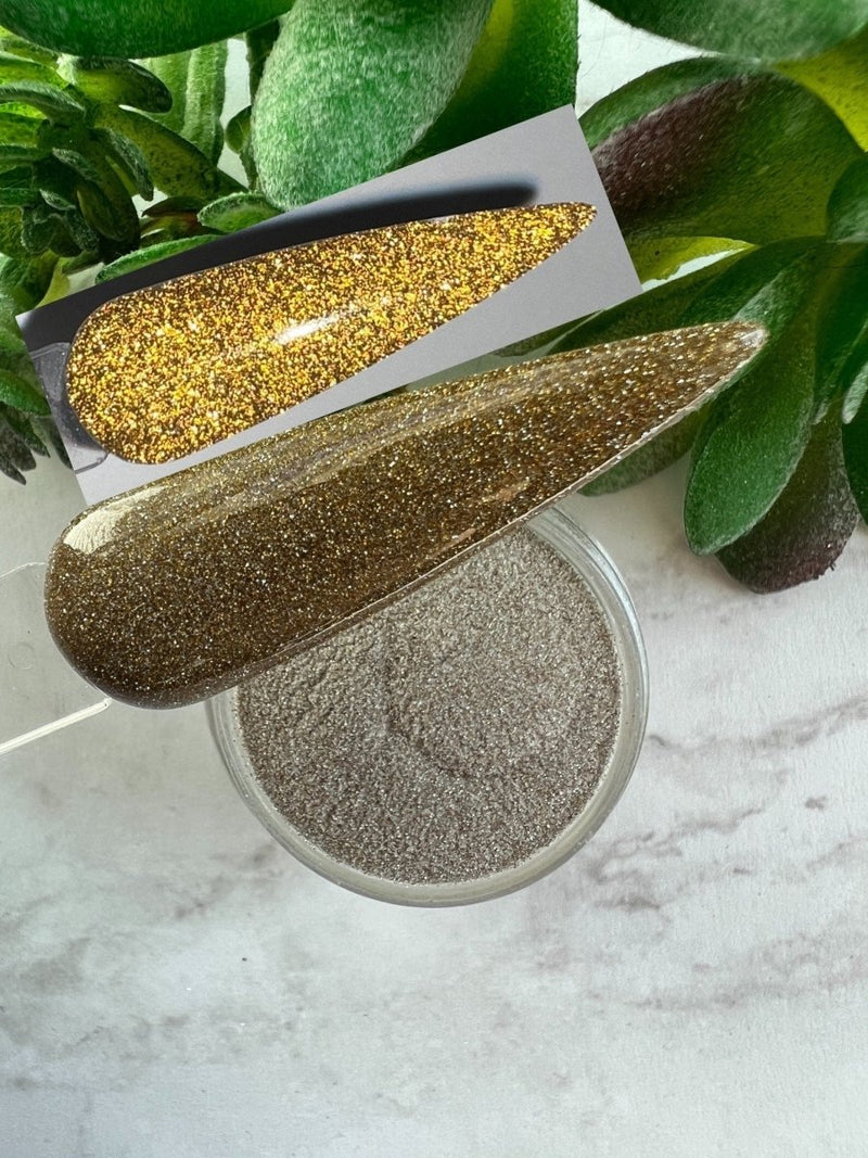 Photo shows swatch of Dipnotic Nails Reflect Gold Reflective Glitter Nail Dip Powder
