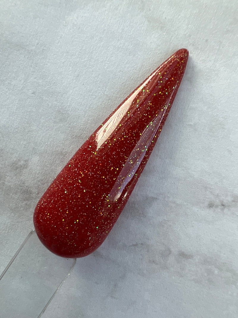 Photo shows swatch of Dipnotic Nails Sagittarius Red Nail Dip Powder Stardust Collection