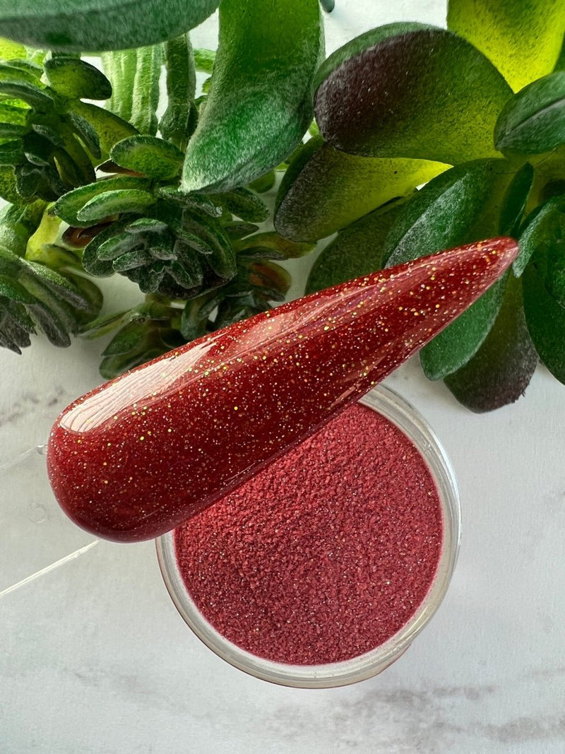 Photo shows swatch of Dipnotic Nails Sagittarius Red Nail Dip Powder Stardust Collection