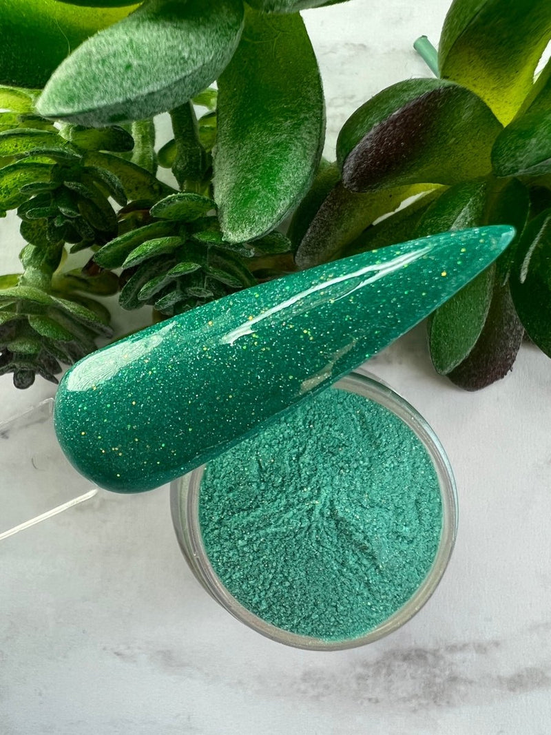 Photo shows swatch of Dipnotic Nails Scorpio Teal Nail Dip Powder Stardust Collection