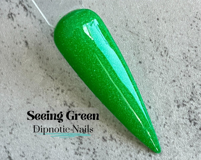 Photo shows swatch of Dipnotic Nails Seeing Green Kelly Green Nail Dip Powder The Irish for a Day Collection
