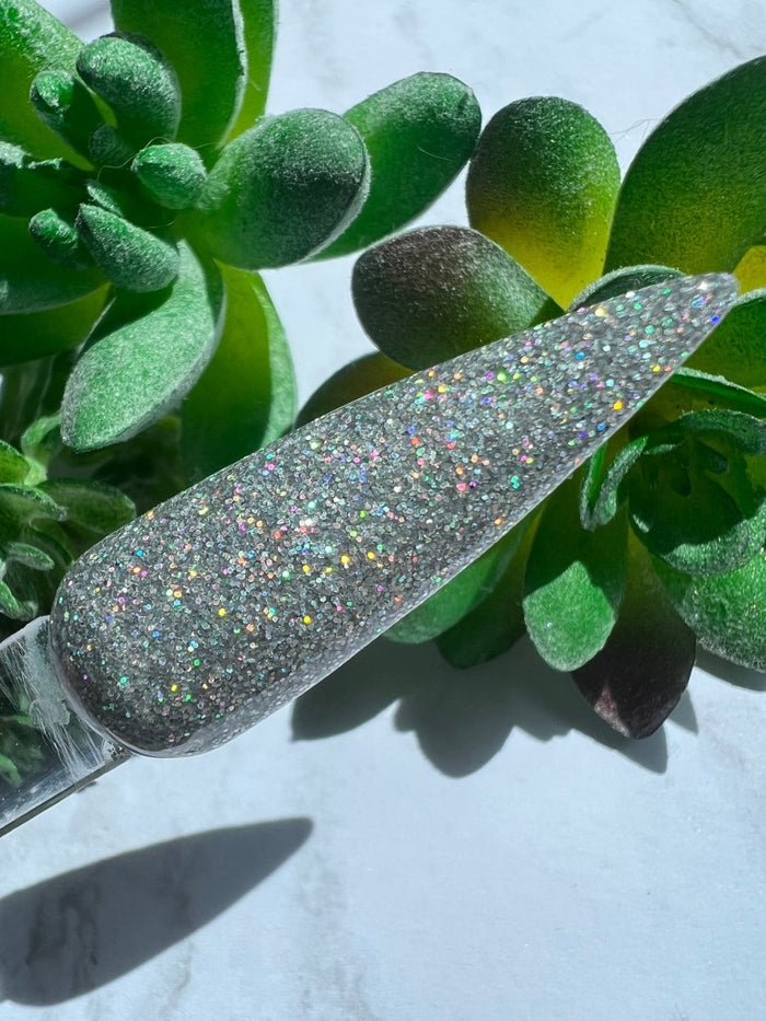 Photo shows swatch of Dipnotic Nails Shalom Silver Holographic Nail Dip Powder The Hello Holo Collection