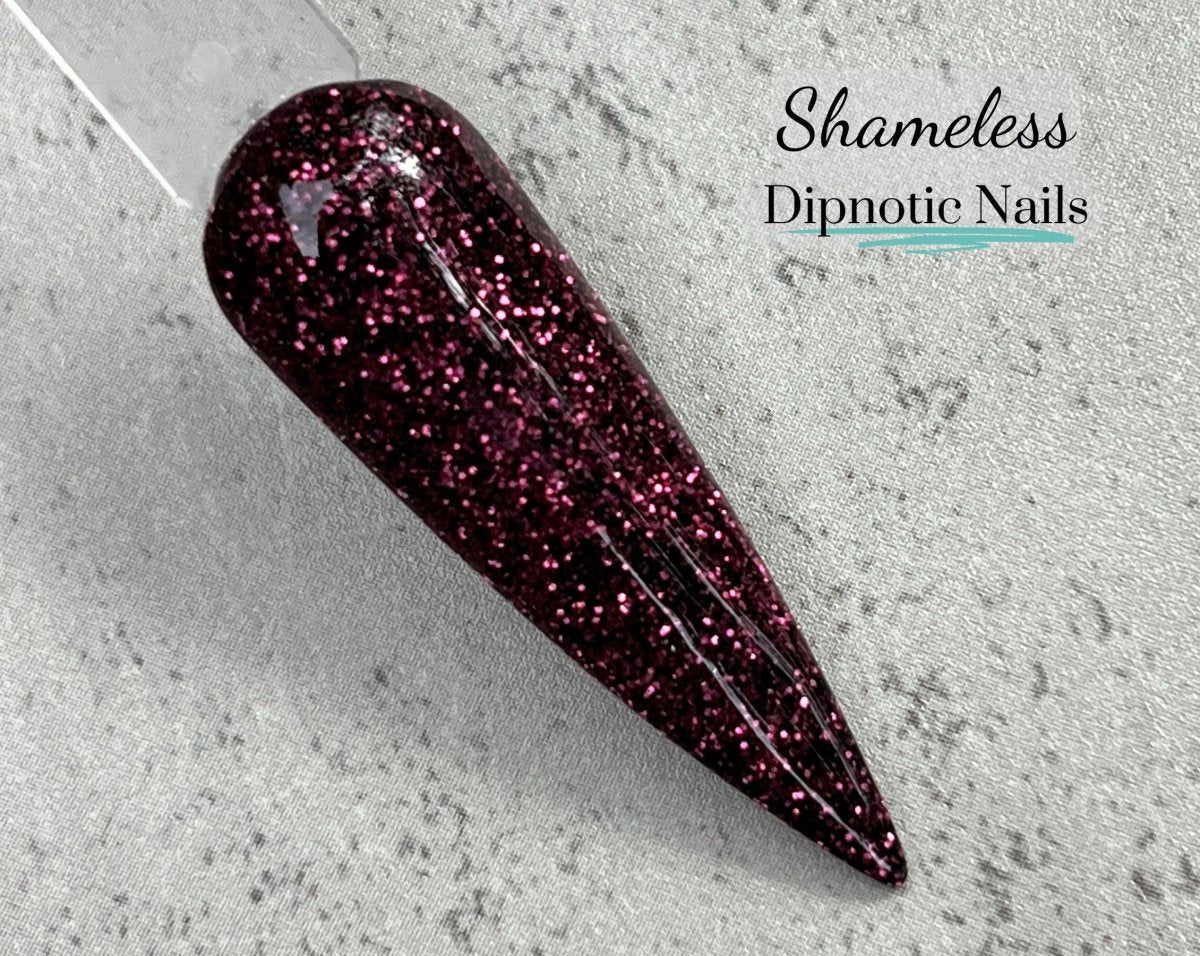 Photo shows swatch of Dipnotic Nails Shameless Dark Burgundy Nail Dip Powder The Solstice Soiree Collection