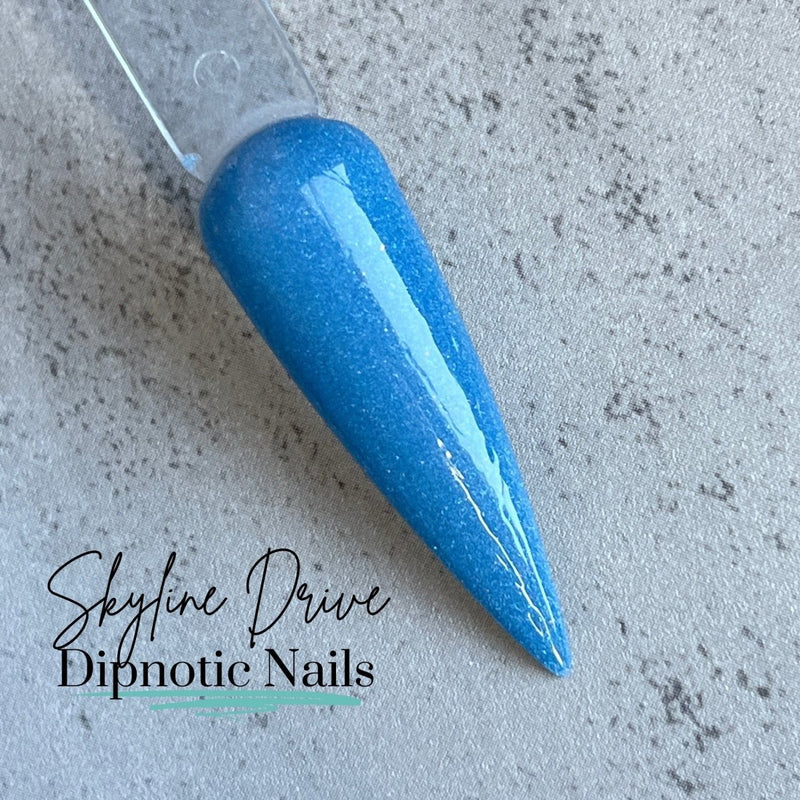 Photo shows swatch of Dipnotic Nails Skyline Drive Blue Dip Powder The Colorado Winter Collection