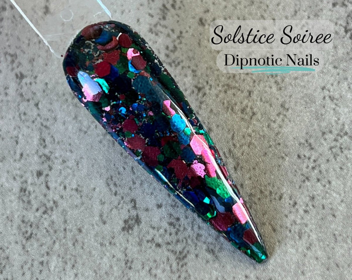 Photo shows swatch of Dipnotic Nails Solstice Soiree Burgundy Blue and Green Nail Dip Powder The Solstice Soiree Collection