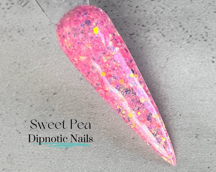 Photo shows swatch of Dipnotic Nails Sweet Pea Pink Nail Dip Powder The April Showers and May Flowers Collection