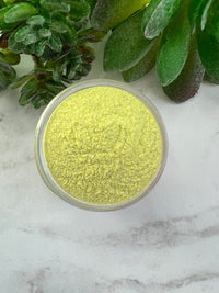 Photo shows swatch of Dipnotic Nails Taurus Yellow Nail Dip Powder Stardust Collection