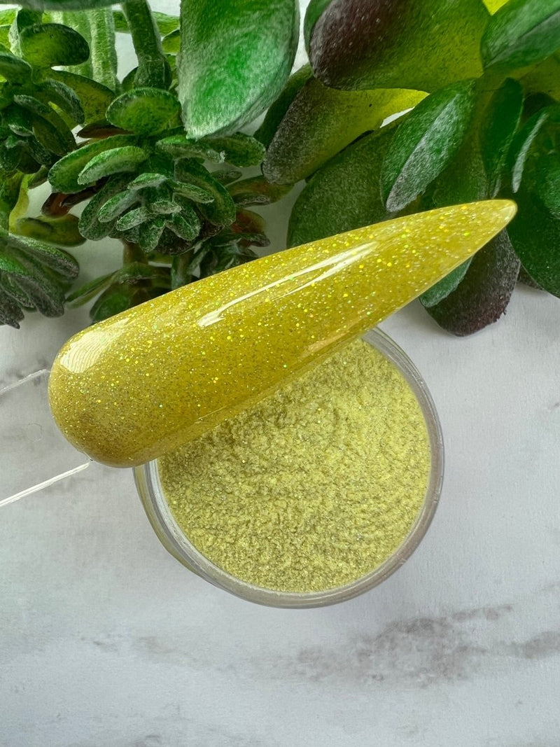 Photo shows swatch of Dipnotic Nails Taurus Yellow Nail Dip Powder Stardust Collection